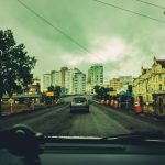 Obras viárias em andamento em uma rua cercada por prédios e estruturas urbanas.